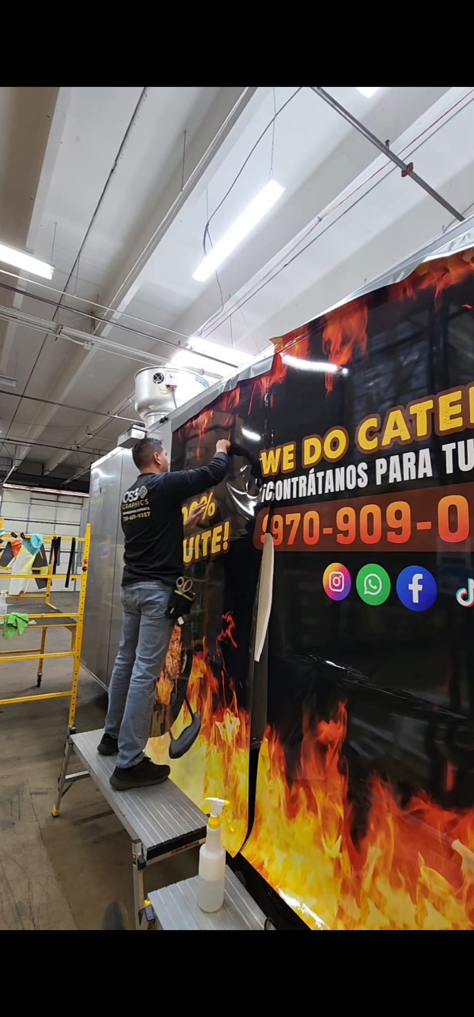 Hector Avila installing Pollos Yuka food truck wrap in Denver